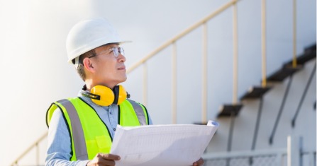 an engineer inspecting a fuel storage tank